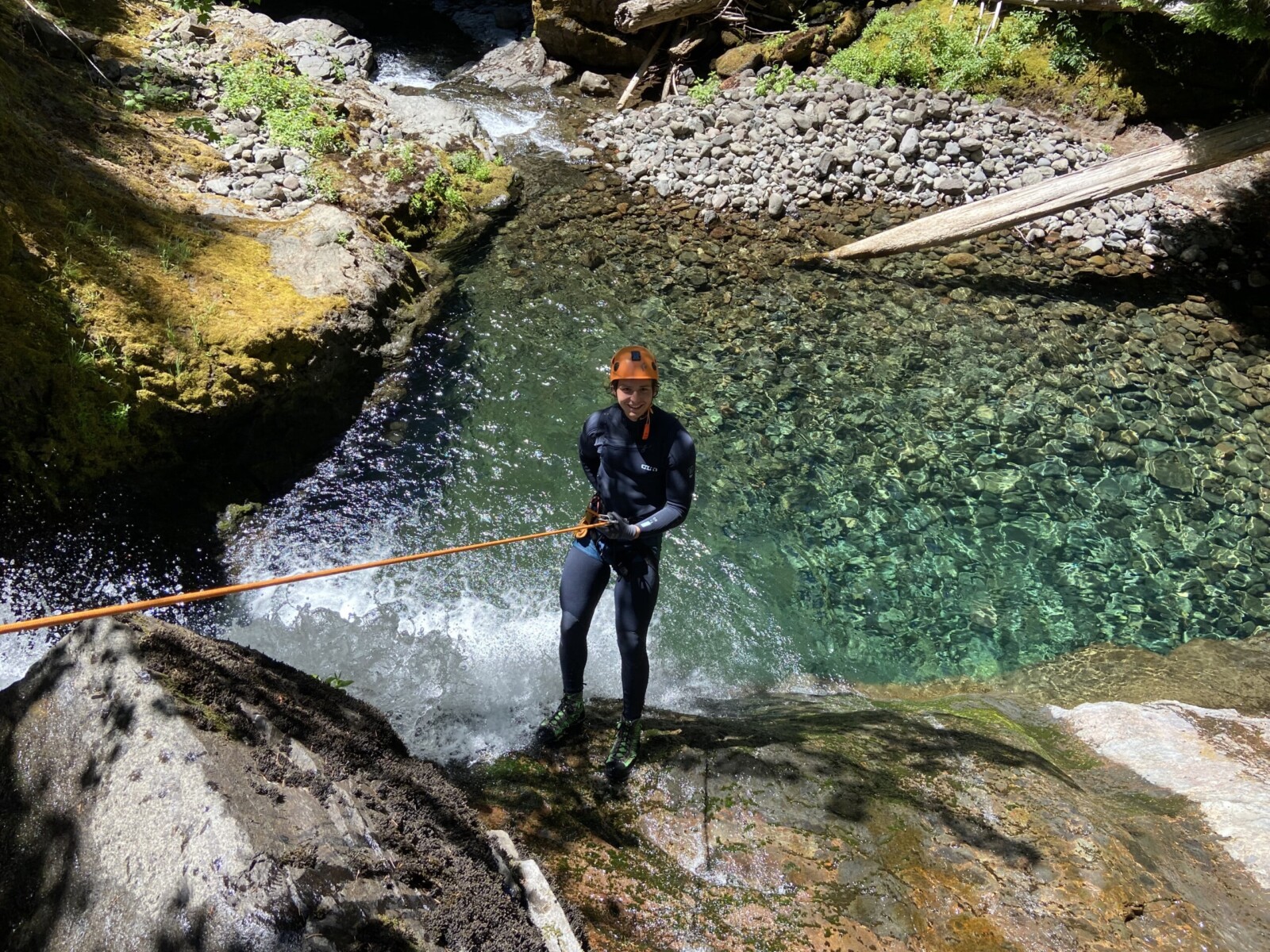 Person rapelling down a waterfall in the Columbia River Gorge.